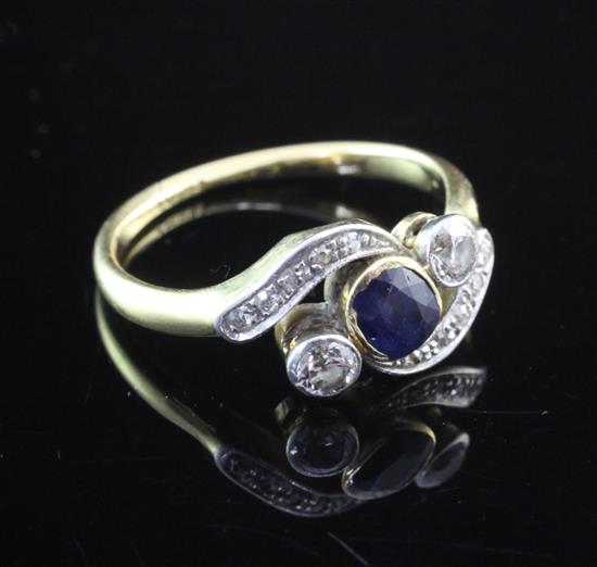 A 1940s/1050s 18ct gold, diamond and sapphire crossover ring, size N.
